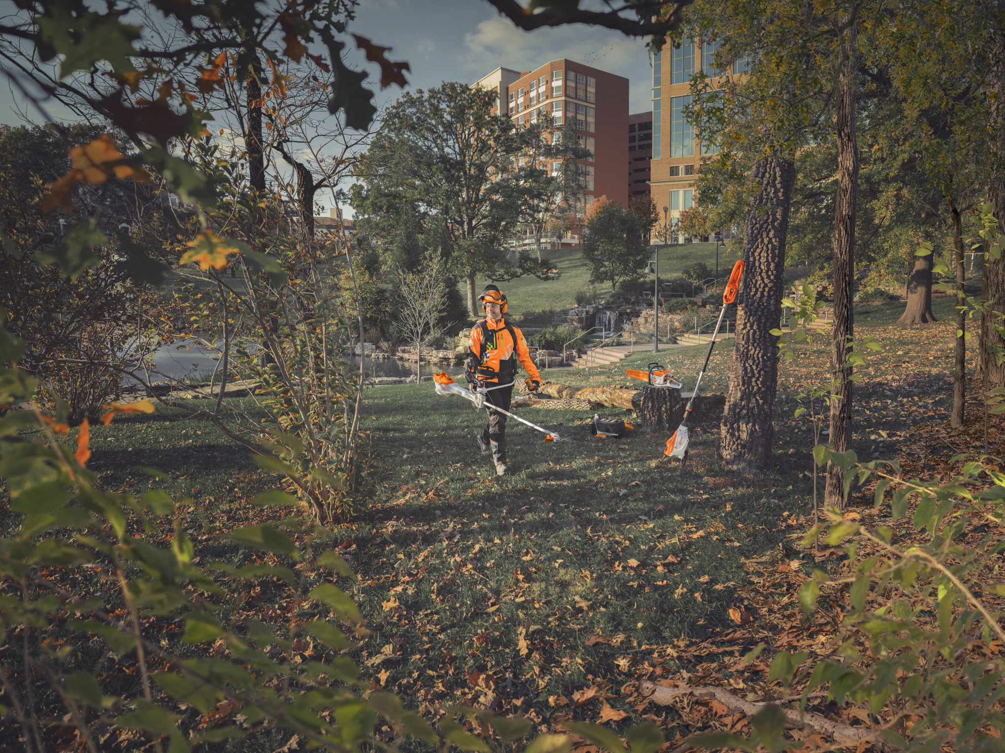 Forestry worker with battery-operated tools for maintaining young stands