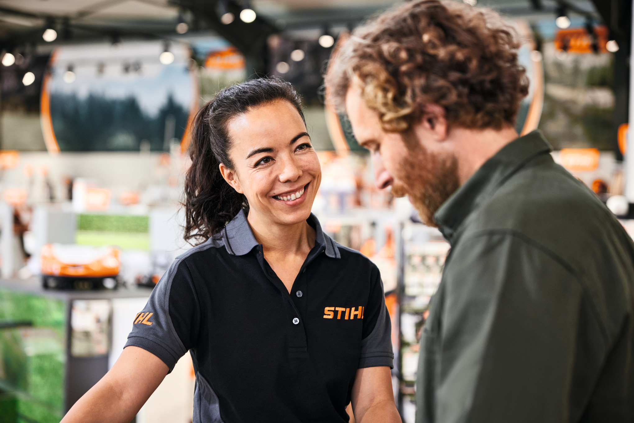A STIHL dealer employee advises a customer