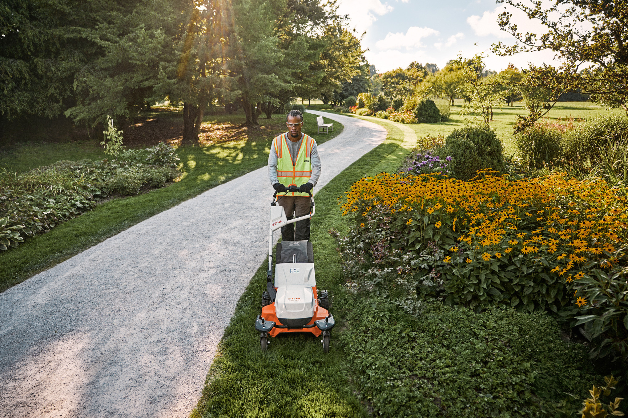 An individual mowing there lawn with a STIHL battery lawn mower. 