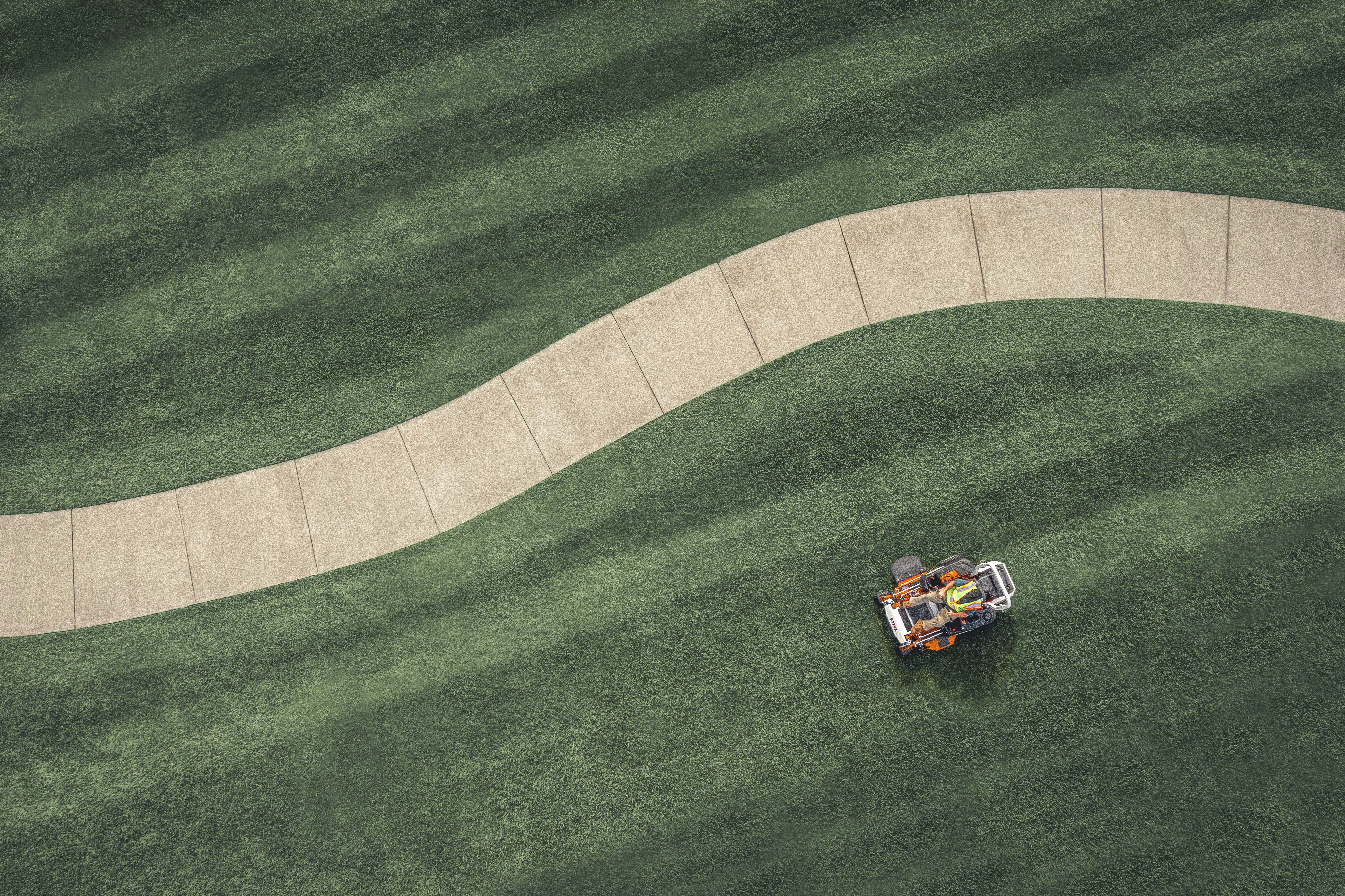 Mowing a lawn with a STIHL zero turn mower.